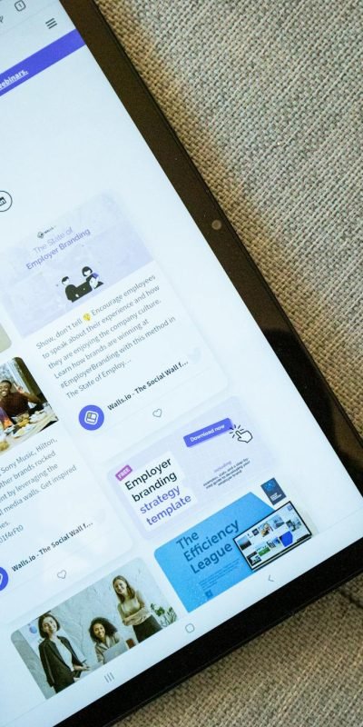 A tablet on a couch showing the Wallis.io website interface.